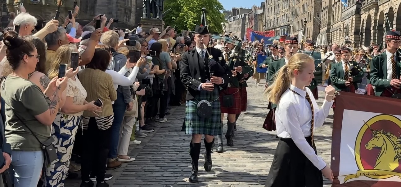 Pipe band marching on the Royal Mile, Tartan Day